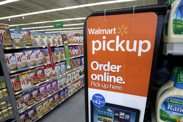 FILE - A sign encouraging customers to order grocery items online and pick them up at a store is displayed at a WalMart Neighborhood Market in Bentonville, Ark., Thursday, June 4, 2015. Walmart is the latest company to join the growing flock of major advertisers to pull spending from X, Elon Musk’s beleaguered social media company, amid concerns about hate speech — as well as reaching a sizeable audience on the platform. (AP Photo/Danny Johnston, File)