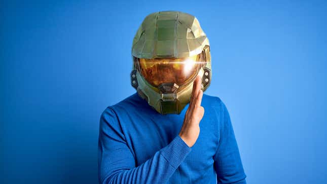 A man with a Master Chief helmet Photoshopped on his shoulders whispers to you.