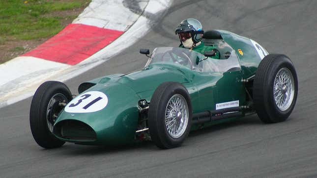 A photo of a vintage green Aston Martin race car. 