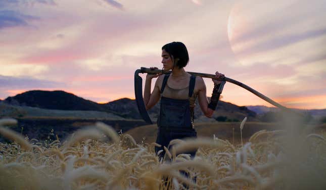 Sofia Boutella in Rebel Moon holding a scythe.