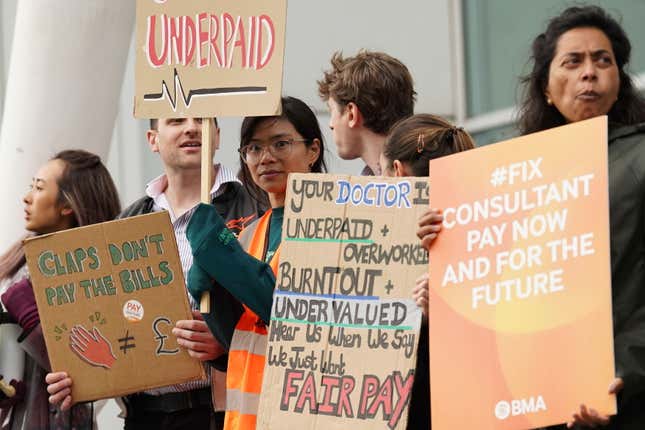 Junior doctors and medical consultants stand on the picket line outside University College Hospital in London, amid their dispute with the government over pay, on Wednesday, Sept. 20, 2023. (Stefan Rousseau/PA via AP)