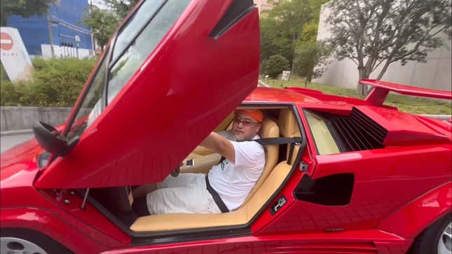 Hideki Kamiya stares at the camera from inside his red Lamborghini.