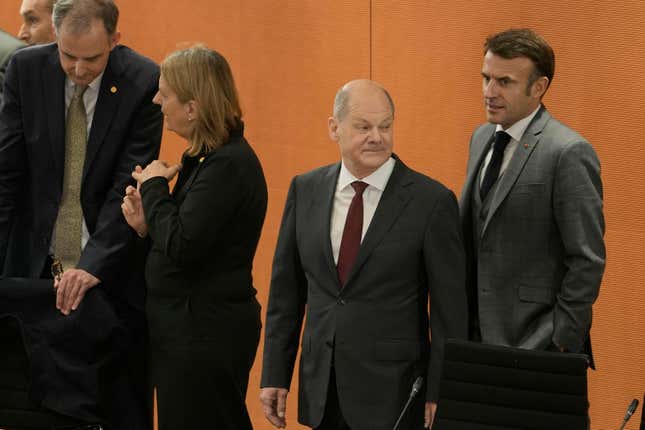 German Chancellor Olaf Scholz, second right, and French President Emmanuel Macron, right, arrive at the G20 Investment Summit - German Business and the CwA Countries on the sidelines of a Compact with Africa in Berlin, Germany, Monday, Nov. 20, 2023. In the high-level conference investment summit the African Compact partner countries meet with high-ranking representatives of German companies to explore investments under the framework of the G20 partnership with Africa. (AP Photo/Markus Schreiber, Pool)