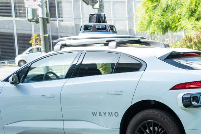 Waymo self-driving car on a road in San Francisco, California without a safety driver visible.