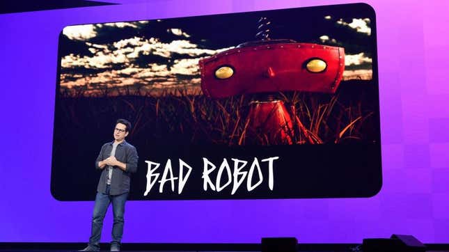 J.J. Abrams stands on a stage in front of the Bad Robot logo at an HBO Max WarnerMedia Investor Day Presentation in 2019.