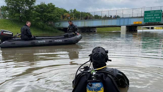 A Michigan State Police diver on the highway after heavy rains inundated the Detroit area.