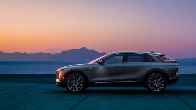 A photo of a silver Cadillac Lyriq SUV at sunset. 