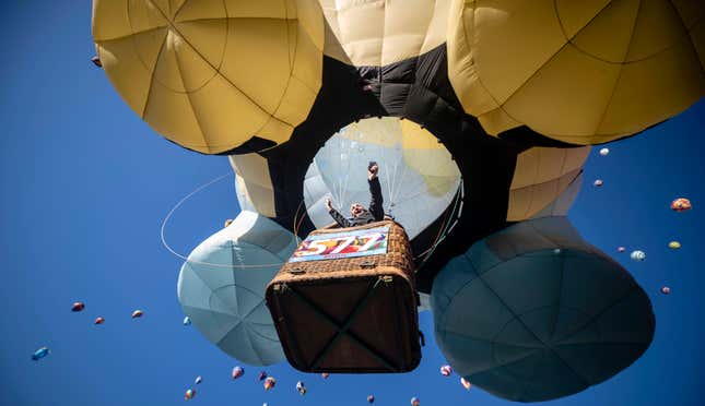 Pilot Pilip Audenaert, of Brazil, rejoices as he takes off during the mass accession at the Albuquerque International Balloon Fiesta, Saturday, Oct. 7, 2023, in Albuquerque, N.M. (AP Photo/Roberto E. Rosales)