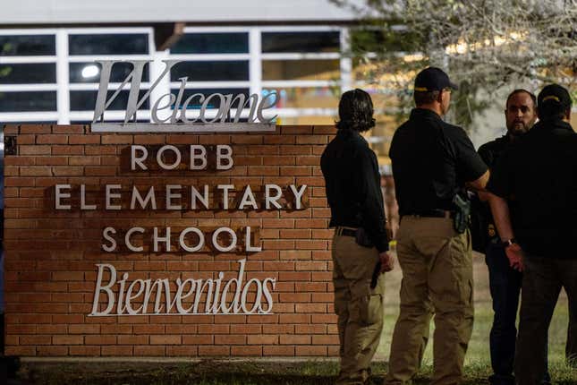 Law enforcement officers speak together outside of Robb Elementary School following the mass shooting at Robb Elementary School on May 24, 2022, in Uvalde, Texas.