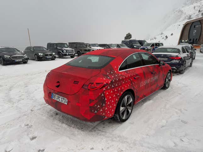 Rear 3/4 view of a camouflaged Mercedes-Benz CLA EV prototype