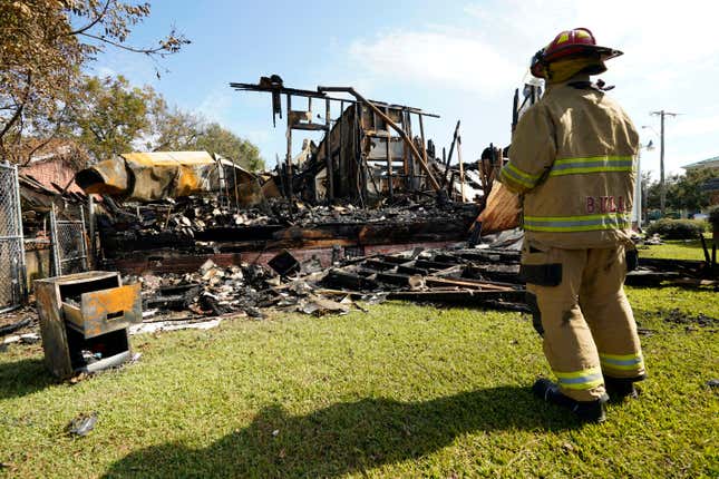 A fireman observes the remains of a burned Epiphany Lutheran Church near midtown Jackson, Miss., Tuesday, Nov. 8, 2022. 