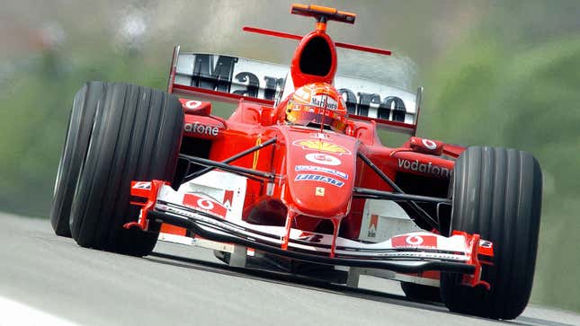 A photo of Michael Schumacher driving a 2004 Ferrari F1 car. 
