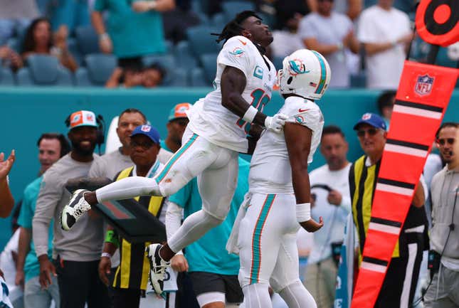 MIAMI GARDENS, FLORIDA – OCTOBER 15: Tyreek Hill #10 of the Miami Dolphins celebrates a touchdown with Tua Tagovailoa #1 during the second quarter of the game against the Carolina Panthers at Hard Rock Stadium on October 15, 2023 in Miami Gardens, Florida.  (Photo by Megan Briggs/Getty Images)