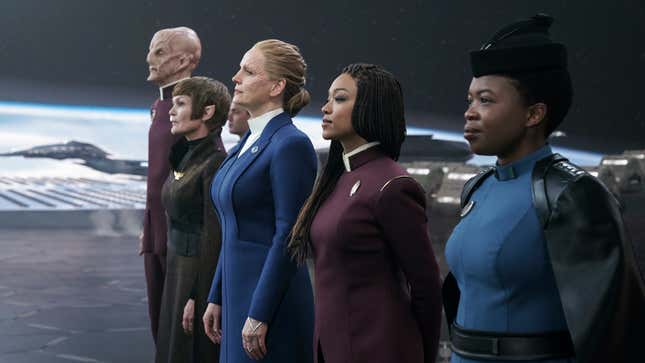 Captains Saru and Burnham, presidents T'Rina and Rillak, and General Ndoye wait for the arrival of a guest in Discovery's shuttlebay.