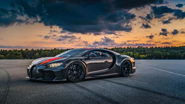 A photo of a black and orange Bugatti Chiron hypercar. 