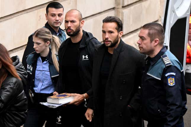 An image of Andrew Tate escorted by Romanian police to a Bucharest courthouse on January 10.