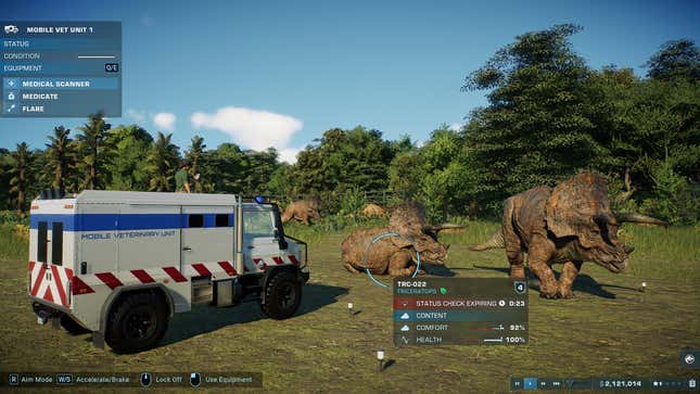 A veterinary ambulence is parked near some triceratops.
