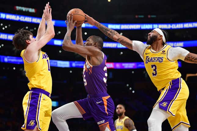 Oct 26, 2023; Los Angeles, California, USA; Phoenix Suns forward Kevin Durant (35) moves to the basket against Los Angeles Lakers guard Austin Reaves (15) and forward Anthony Davis (3) during the first half at Crypto.com Arena.