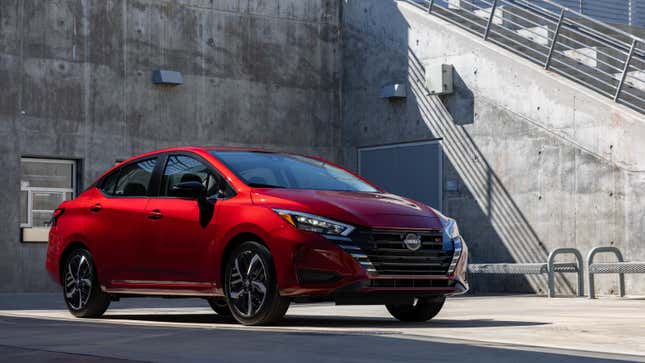 A photo of a red Nissan Versa. 