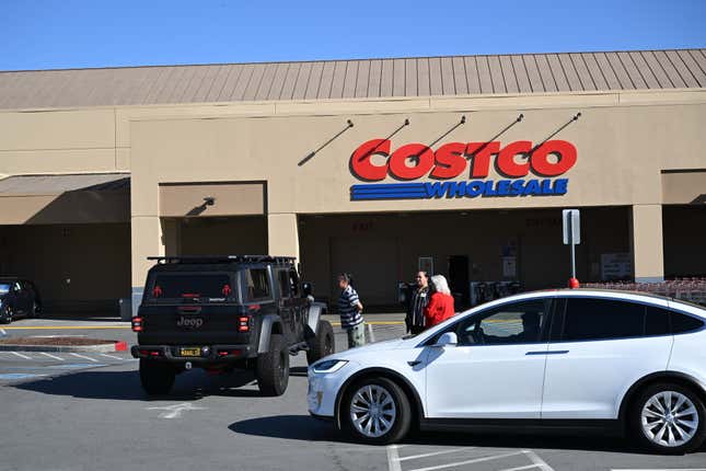 Workers speak with customers about power outages outside a closed Costco in Foster City, California on Jan., 16, 2025.