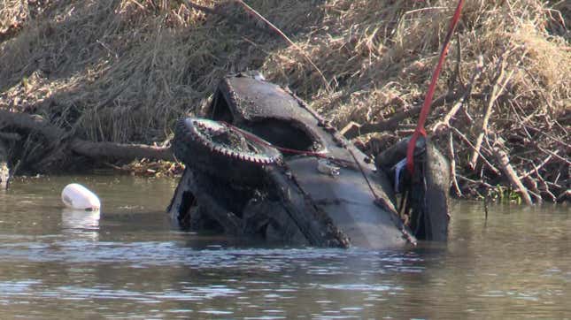 The submerged Chevrolet Impala being pulled from the river