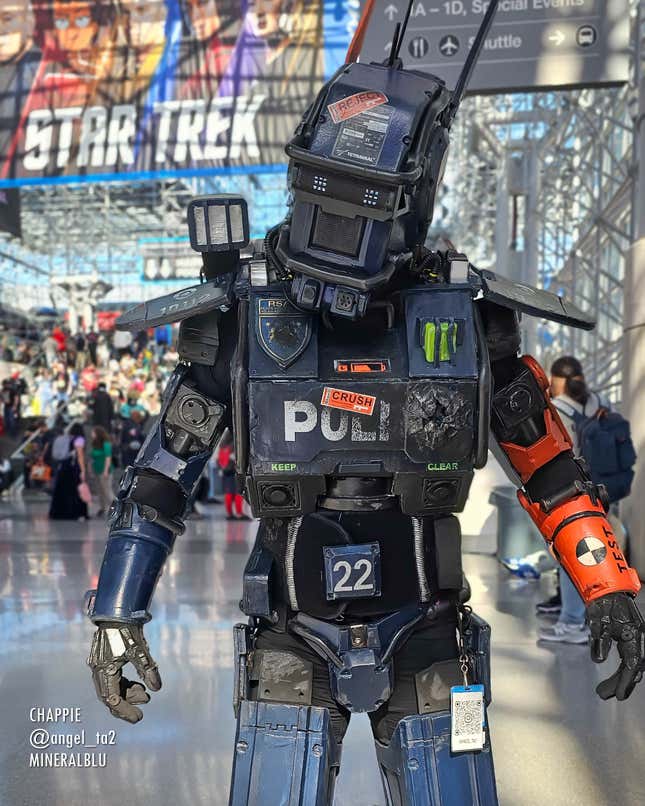 A cosplayer stands in the Javits Center atrium dressed as Chappie.