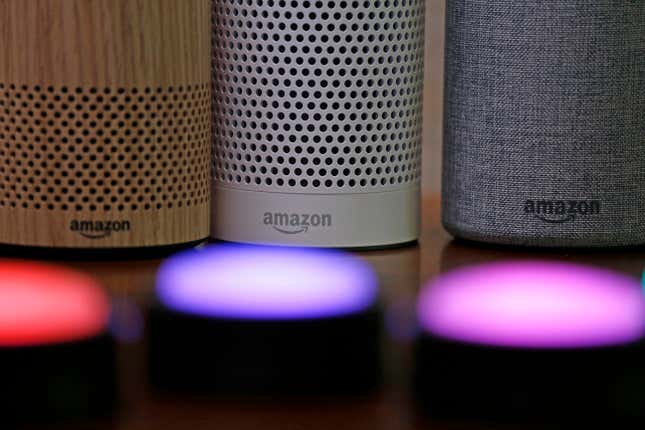 FILE - Amazon Echo and Echo Plus devices, behind, sit near illuminated Echo Button devices during an event announcing several new Amazon products by the company, Sept. 27, 2017, in Seattle. Amazon is cutting hundreds of jobs in the unit that handles Alexa, its popular voice assistant. In a note to employees on Friday, Nov, 17, 2023, Daniel Rausch, Amazon’s vice president of Alexa and Fire TV, wrote the company was eliminating certain roles because it was ditching some initiatives. (AP Photo/Elaine Thompson, File)