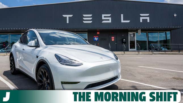 A photo of a Tesla Model Y electric SUV in front of a building. 