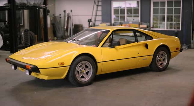 Yellow Ferrari 308 GTBi in a garage.