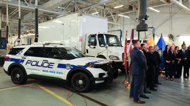 The truck used in the robbery is seen behind the speakers. Peel Regional Police and the US Alcohol, Tobacco and Firearms Bureau announced details and arrests made concerning the theft of 20 million dollars in gold from Pearson International Airport.