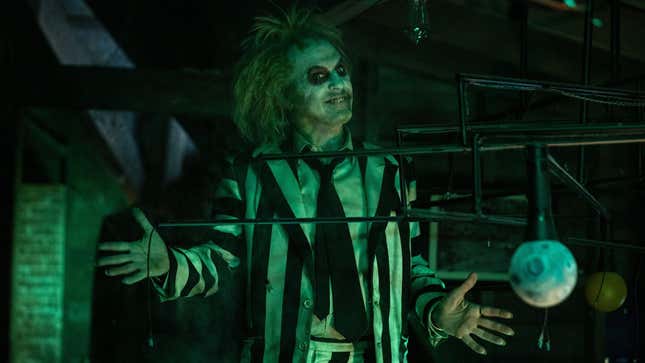 Beetlejuice stands with his hands outstretched. 