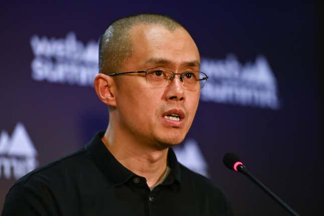 A close-up of Changpeng Zhao, who stands in front of a microphone