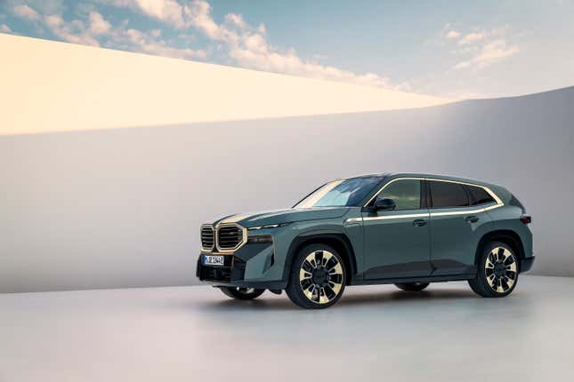 A violently over-styled SUV sits parked in front of a white wall.