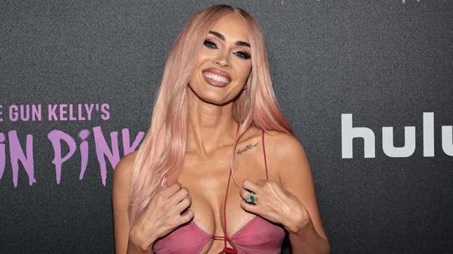 Image for article titled Megan Fox Reads Witchcraft Book (Sans Engagement Ring) Amid Split Rumors