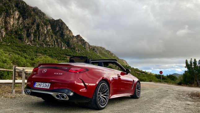 a rear three quarters view of a red CLE 53 Cabriolet in front of mountains