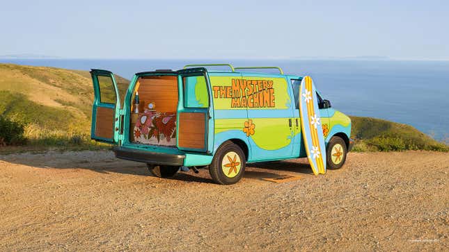 The green and blue Mystery Machine is shown near the coast.