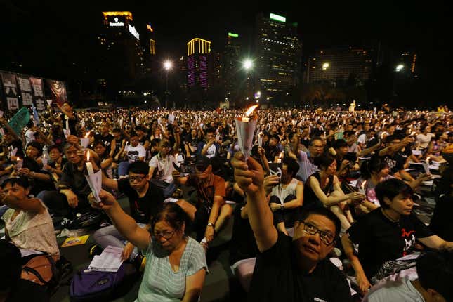 People take part in a candlelight vigil at Hong Kong's Victoria Park on 25th anniversary of June 4th military crackdown on pro-democracy movement in Beijing
