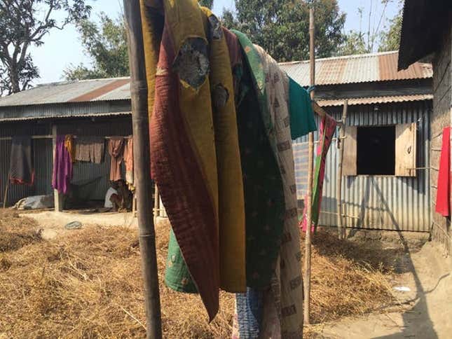 Sesame plants and handmade quilts dry in a small village on the outskirts of Barpeta, Assam.