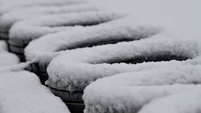 A row of tires covered in snow 