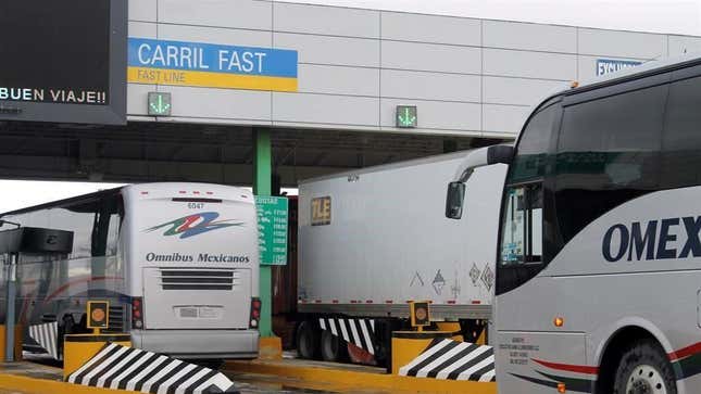 Commercial trucks and buses crossing to the U.S. through the Colombia Solidarity Bridge in Mexico.