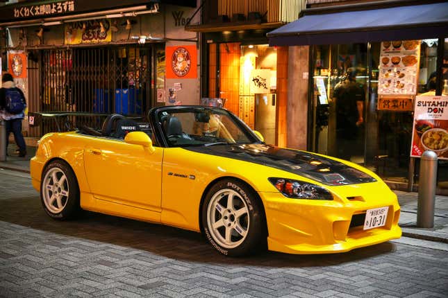 Tokyo, Japan - January 11, 2025: Bright yellow roadster car Honda S2000 in the city street.