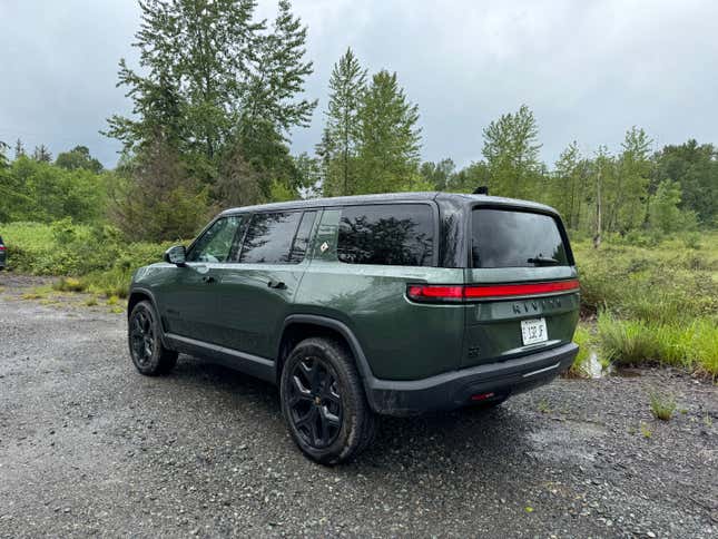 Rear 3/4 view of a green Rivian R1S