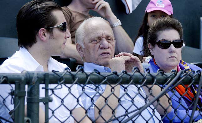 FILE - Peter G. Angelos, center, owner of the Baltimore Orioles, sits in the owners box at Ft.Lauderdale Stadium in Ft. Lauderdale, Fla. with his son, Louis, and wife, Georgia, during his team&#39;s spring training baseball game against the Boston Red Sox Sunday, March 18, 2007. Peter Angelos, owner of a Baltimore Orioles team that endured long losing stretches and shrewd proprietor of a law firm that won high-profile cases against industry titans, died Saturday, March 23, 2024. He was 94. (AP Photo/James A. Finley, File)