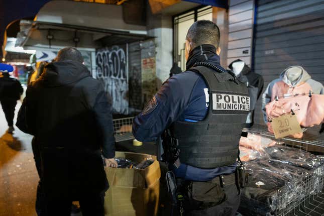 This photograph shows counterfeit clothes seized by members of the municipal police in the back of a car during an anti-counterfeiting operation at the Saint-Ouen flea market in northern Paris