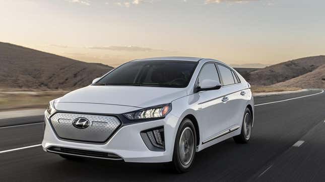 A white Hyundai Ioniq EV driving on a road