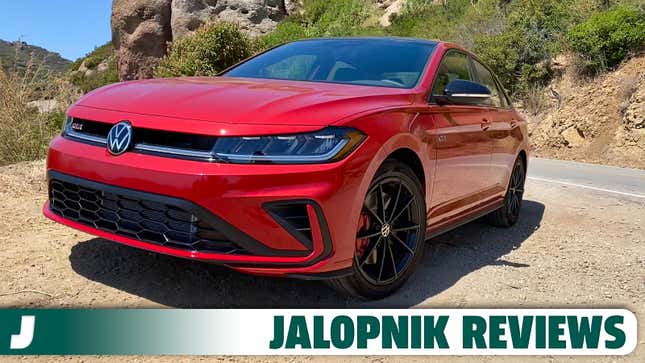 a front 3/4 shot of the kings red Jetta GLI parked on dirt in front of a mountain