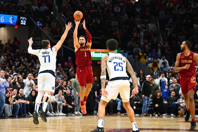 CLEVELAND, OHIO - FEBRUARY 27: Max Strus #1 of the Cleveland Cavaliers shoots a half-court shot over Luka Doncic #77 of the Dallas Mavericks to defeat the Mavericks in the last second of the fourth quarter at Rocket Mortgage Fieldhouse on February 27, 2024, in Cleveland, Ohio. The Cavaliers defeated the Mavericks 121-119. NOTE TO USER: User expressly acknowledges and agrees that, by downloading and or using this photograph, User is consenting to the terms and conditions of the Getty Images License Agreement. (Photo by Jason Miller/Getty Images)