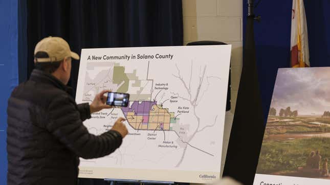 An attendee of a California Forever news conference photographs a map in Rio Vista, California, US, on Wednesday, Jan. 17, 2024. 