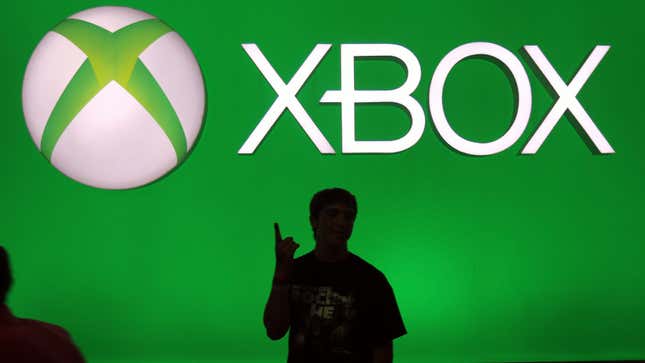 A peron's silhouette points up at an Xbox logo during Gamescom in August 2013. 