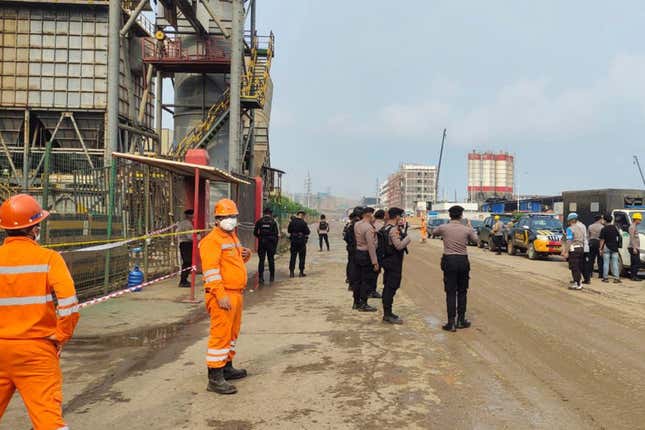 Police officers and workers stand near the site where a furnace explosion occurred at PT Indonesia Tsingshan Stainless Steel smelting plant in Morowali, Central Sulawesi, Indonesia, Sunday, Dec. 24, 2023. A smelting furnace has exploded at the Chinese-owned nickel plant on Indonesia&#39;s Sulawesi island, killing a number of workers and injuring dozens of others. The explosion on Sunday was the latest of a series of deadly accidents in nickel smelting plants in Indonesia that are part of China&#39;s ambitious transnational development program known as the Belt and Road Initiative. (AP Photo)